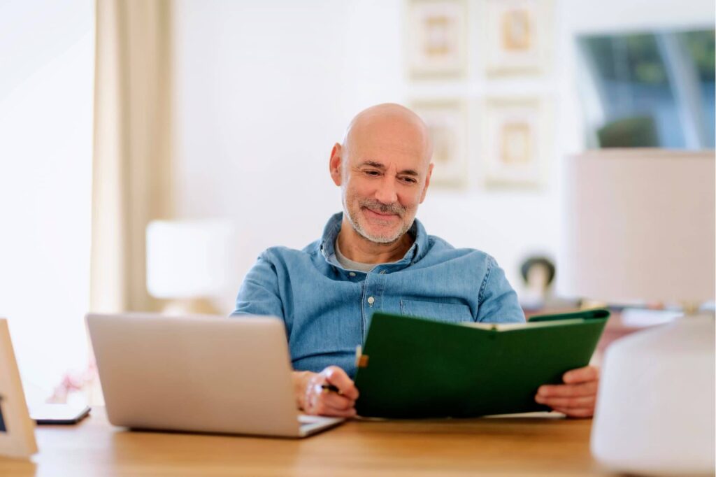 Surgeon reviewing financial reports in a calm home setting, symbolizing clarity through passive real estate investing.