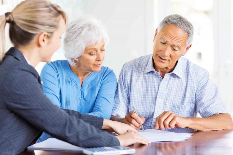 Financial advisor explaining investment plans to senior couples.