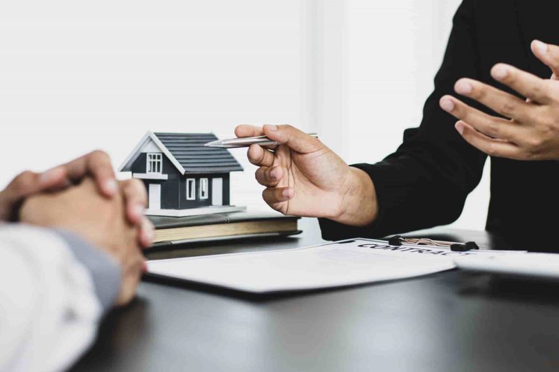 Real estate agent showing contract to client