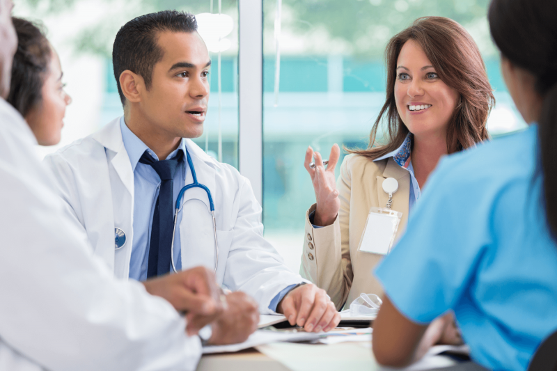 Physician engaged in a strategic discussion about real estate investing, reflecting clarity, confidence, and long-term vision.